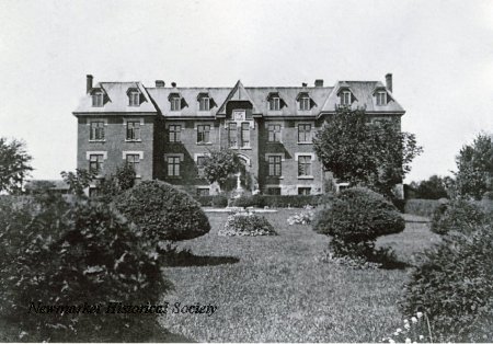 Historic photograph of the substantial multi-storey York County Industrial Home in Newmarket, with formal grounds in the foreground