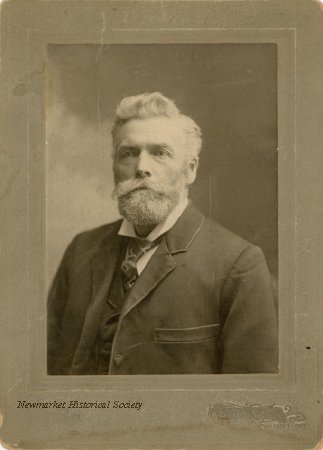 Archival studio portrait of Joseph Collins Lundy, with a white beard and dark suit