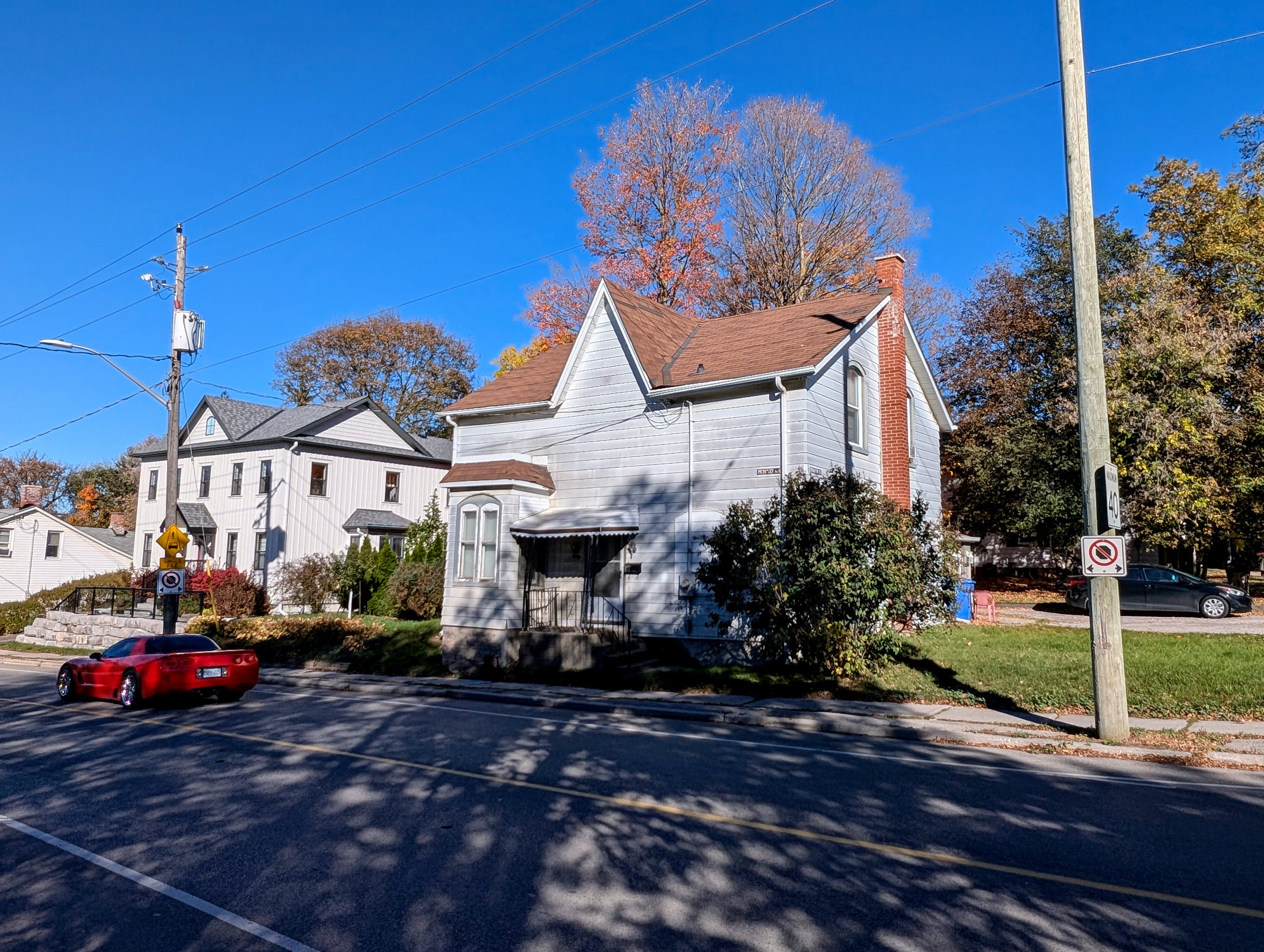311 Prospect Street in October 2026, showing its front gable, tall brick chimney, projecting bay window and porch