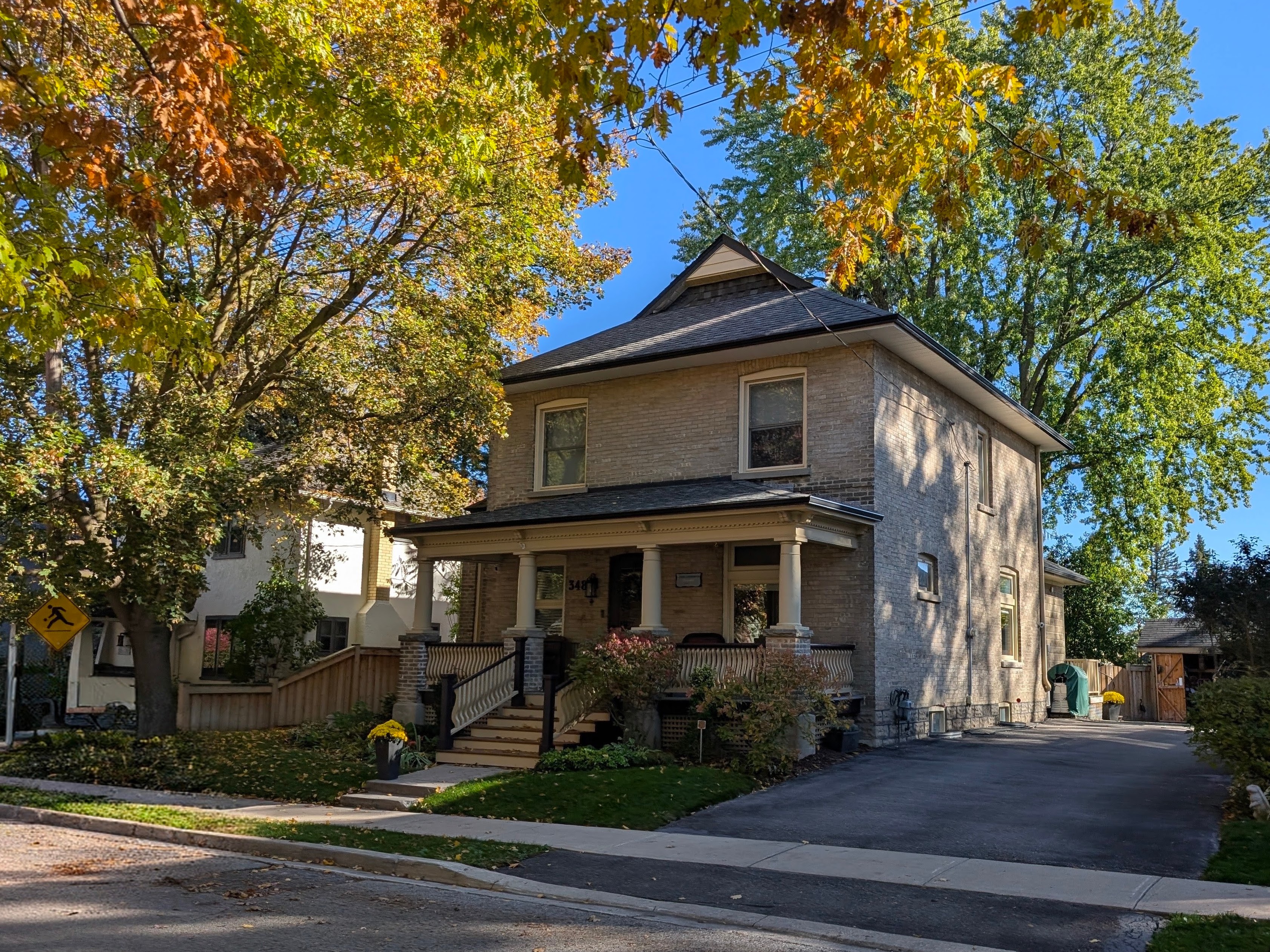 348 Botsford Street on a sunny autumn day in October 2026, showing the brick house, front verandah and tree-lined streetscape